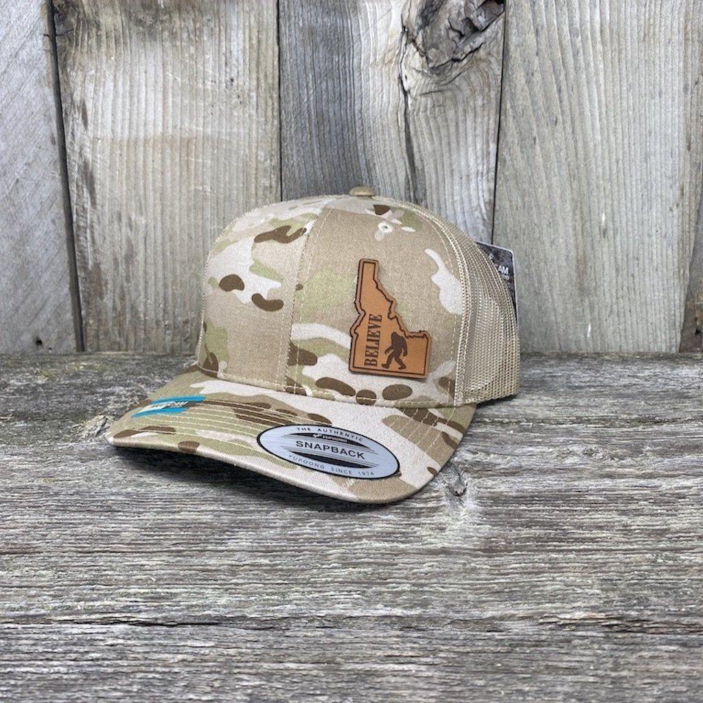 BIGFOOT IDAHO LEATHER PATCH HAT FLEXFIT Leather Patch Hats Hells Canyon Designs # Arid/Tan Multi-cam